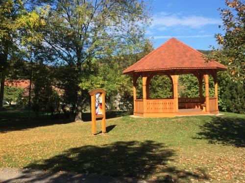 a gazebo with a bench in a park at Appartments Rue Des Châteaux in Ottrott