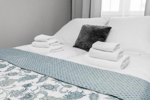 a bed with towels and a pillow on it at Apartament Gemini in Dzierżoniów