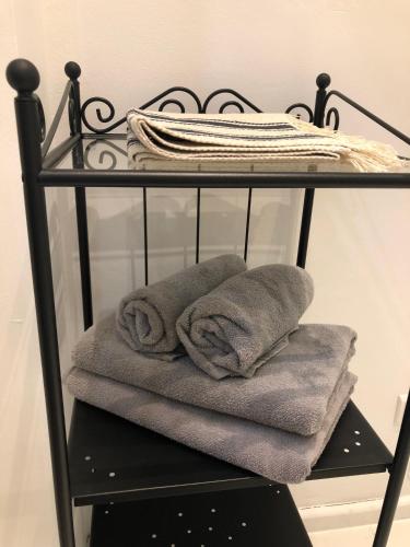 a black towel rack with towels on it at LivingRoom 3 Family Self Check-in 24h in Katowice
