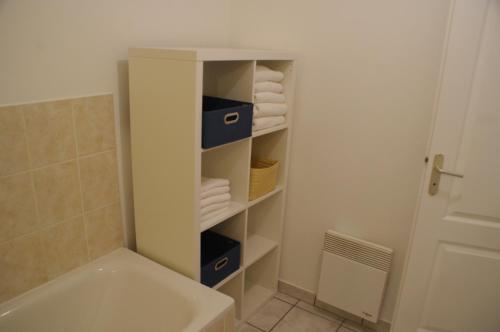 a bathroom with a sink and a bath tub at La Cour Royale in Bayeux