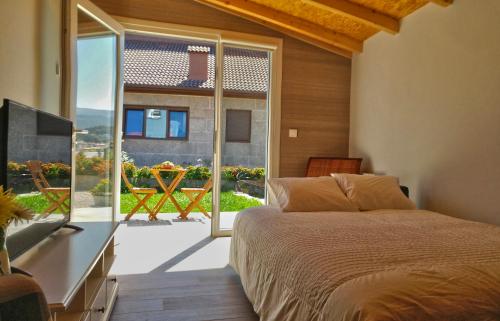 a bedroom with a bed and a large window at Catapeixe Holiday Apartments in Redondela