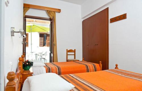 A bed or beds in a room at Stavros Pension