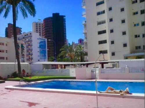 a swimming pool in the middle of a city with buildings at Virginia of the sea in Benidorm