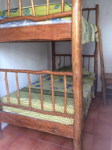 a bunk bed with a wooden bunk bed frame at Casa Canta Rana in Fronteras