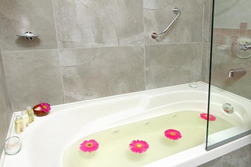 a bathroom with a tub with flowers on it at BA Sohotel in Buenos Aires