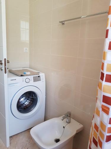 a washing machine in a bathroom with a sink at Bianca in Valencia