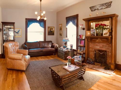 a living room with a couch and a fireplace at Captain's Inn at Moss Landing in Moss Landing