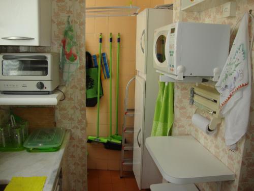 a kitchen with a toilet and a microwave at Recanto Santista in Santos