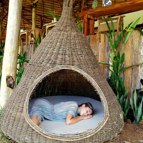 a woman laying in a hammock in a basket at El Valle Lodge in El Valle