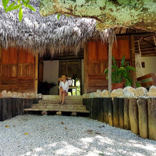 a person sitting on the steps of a house at El Valle Lodge in El Valle