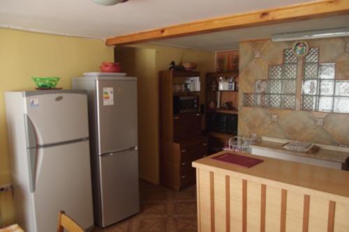 a kitchen with a refrigerator and a counter top at Hostal Miramar in Valparaíso