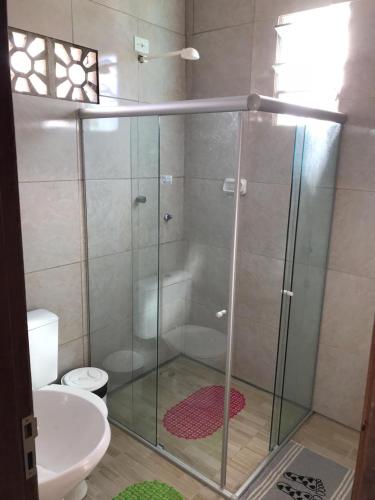 a glass shower in a bathroom with a toilet at Casa de Veraneio Ilha de Itamaracá in Itamaracá