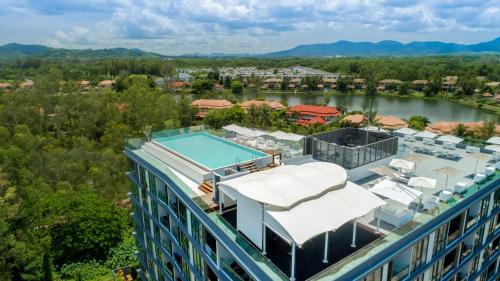 an aerial view of a building with a swimming pool at Oceanstone by RESAVA in Bang Tao Beach