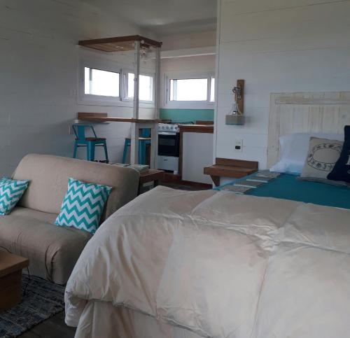 a bedroom with a large bed and a couch at Marasaias in La Pedrera