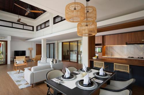 a living room with a dining table and chairs at The Kemilau Hotel & Villa Canggu Bali in Canggu