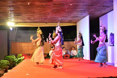 a group of women performing a dance on a stage at Golden Temple Retreat in Siem Reap