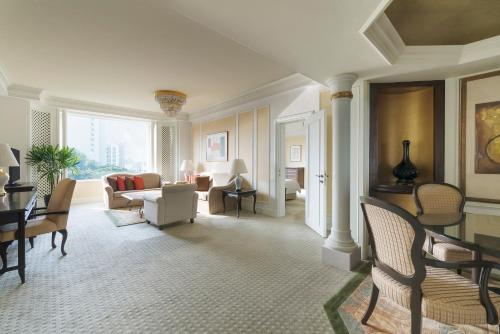 a living room with a couch and a table and chairs at Shangri-La Singapore in Singapore