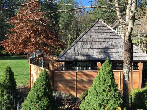a house with a wooden fence and trees at Amante Luxury Bed & Breakfast in Victoria