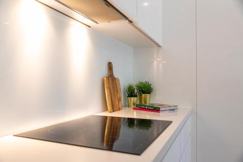 a room with a counter with a table with a light at Location, location, Sunshine Beach in Sunshine Beach