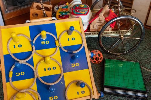 a board game with balls and handcuffs on it next to a laptop at Atami Onsen Sakuraya Ryokan in Atami