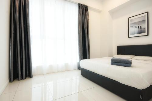 a bedroom with a bed and a large window at KEEN Suites@Sutera Avenue in Kota Kinabalu
