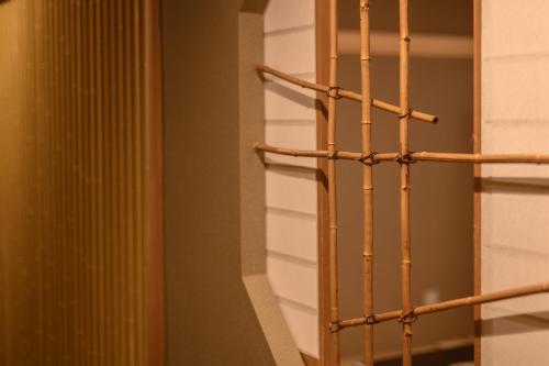 a wooden rack in a room with a wall at Atami Onsen Sakuraya Ryokan in Atami