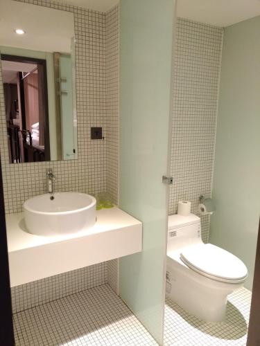 a bathroom with a sink and a toilet at Energy Inn in Taipei