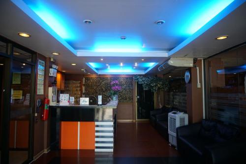 a bar in a room with a blue ceiling at Bangkok Travel Suites Hotel in Nonthaburi