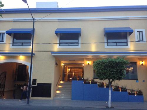 a building with blue awnings on the front of it at Hotel CR Tehuacan in Tehuacán