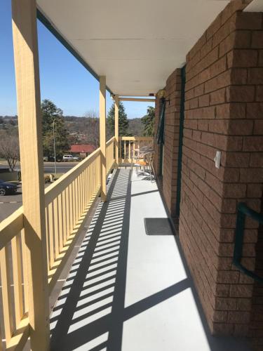 a view from the porch of a brick building at Hideaway Motor Inn in Armidale