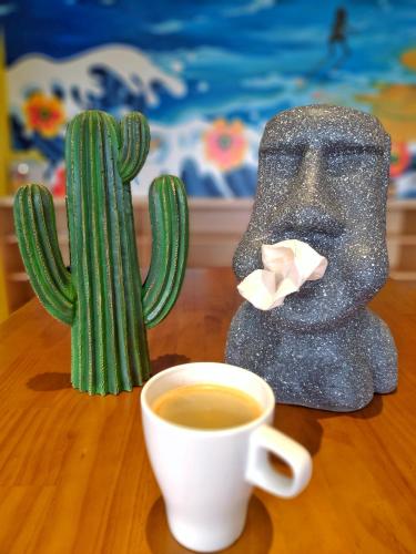 a cup of coffee and a statue of a cactus at Shi Guang Sea View in Magong