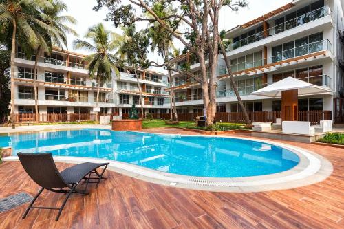 a swimming pool in front of a building at Calangute Wave in Calangute