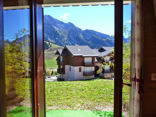 a view of a house from a window at MONT BLANC SOLEIL E-2 in Manigod