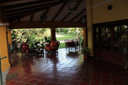 a porch with chairs and tables and a patio at Trapp Family Country Inn in San Antonio
