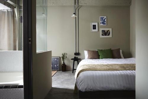 a bedroom with a bed and a tub in a room at Ob-Oon Boutique Bed & Breakfast in Bangkok