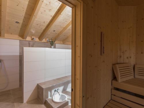 a bathroom with a tub in a wooden house at Saunaloft Schwarzwald in Gemeinde Aichhalden