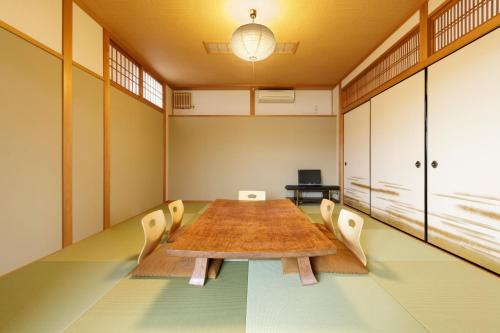 a conference room with a long table and chairs at 日照庵 Nisshouan in Kyoto