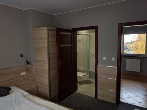 a bedroom with a bed and a sliding glass door at MDS Wielichowo in Wielichowo