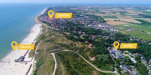 an aerial view of a beach with two yellow signs at Beach Hotel I Kloeg Collection in Zoutelande