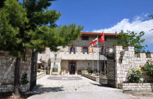 a stone building with a flag in front of it at IL Castello dei Templari in Pietrelcina