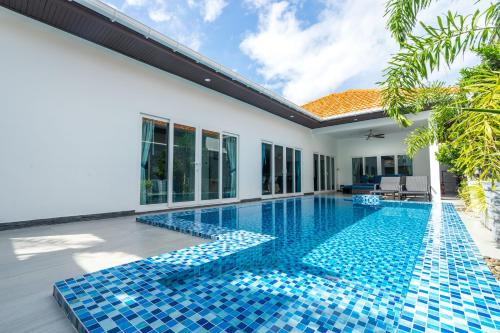 a swimming pool in the backyard of a villa at Majestic by Korawan in Pattaya South
