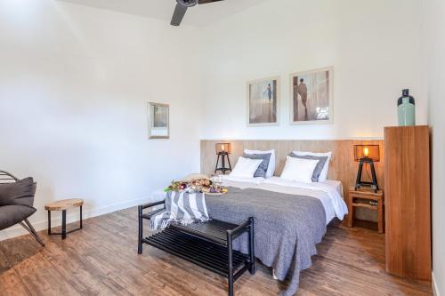 a bedroom with a large bed and a chair at Hajé Hotel Restaurant de Lepelaar in Lelystad