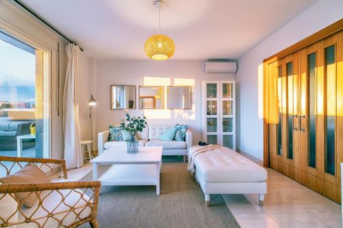 a living room with a couch and a table at Livemálaga Terrace Deluxe in Málaga