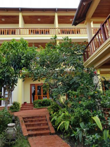 a building with a bunch of trees and stairs at Free Beach Resort in Phu Quoc
