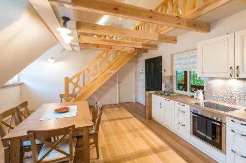 a kitchen with a wooden table and a dining room at Adelinenhof - Ferienapartments, Fasten, Wellness & Gesundheit in Burg