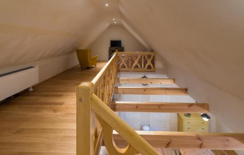 a staircase in a attic with a yellow chair at Adelinenhof - Ferienapartments, Fasten, Wellness & Gesundheit in Burg