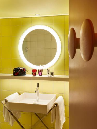 a bathroom with a sink and a mirror at Mama Shelter Toulouse in Toulouse