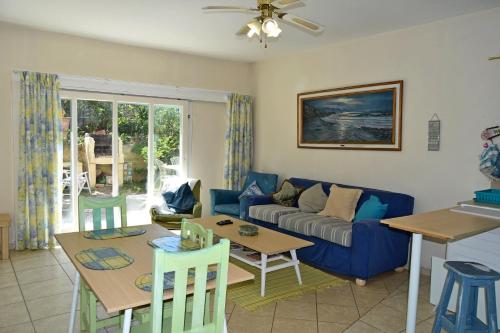 a living room with a couch and a table at Sea Valley Villa in Port Alfred