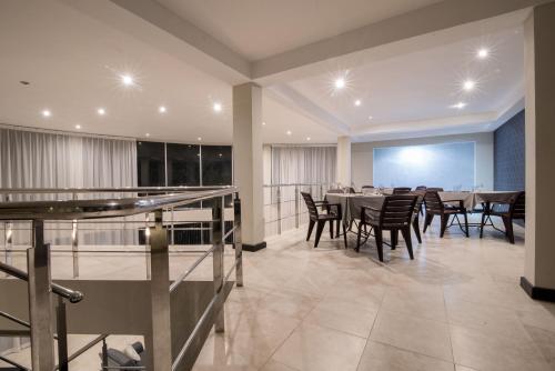 a dining room with a long table and chairs at W Residence Kandy in Kandy