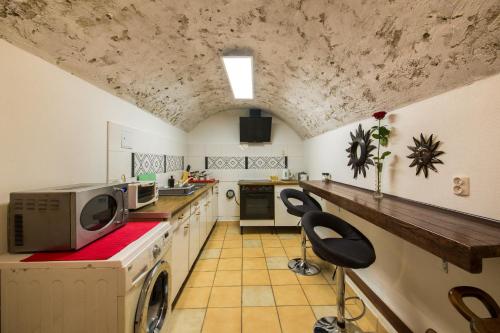 a kitchen with a washer and dryer in a room at Red Carpet Hostel in Krakow